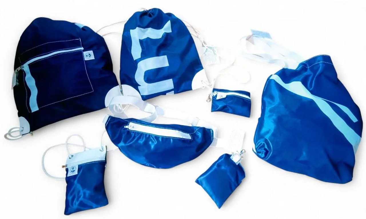 Collection of blue drawstring bags, belt bags and pouches sewn from reclaimed promotional textiles
