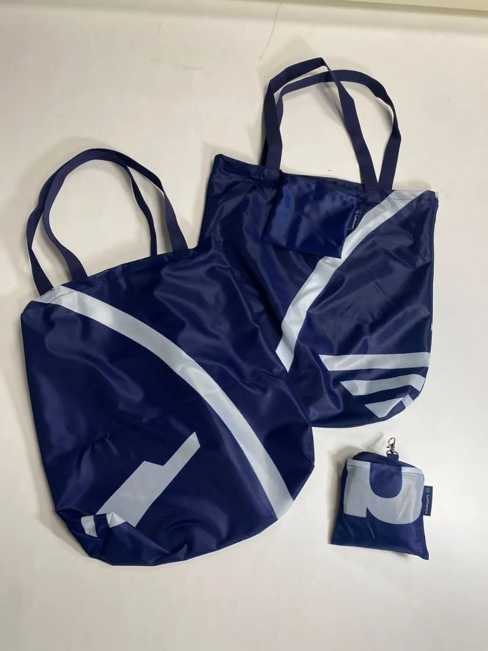 Soft navy promotional textile converted into packable shopping bags