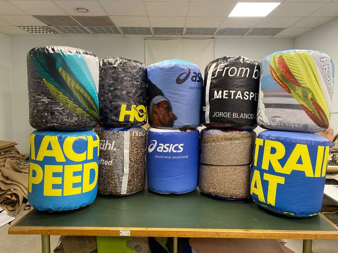 Colorful cylinder poufs made from advertising banner prints